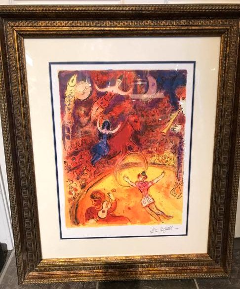 "Circus" Limited Edition Print by Marc Chagall: Framed limited edition print by Marc Chagall numbered 3/99. Framed in a gilded wooden frame. Frame measures approx. 31"h x 26"W.