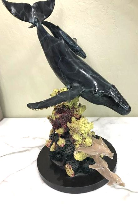 Multi-Patinated Bronze Humpback Whale Statue: Spectacular multi-patinated bronze statue of two humpback whales with dolphins in the coral mounted on a smooth, solid, round black marble base. Has excellent details and is in good condition. Marked.