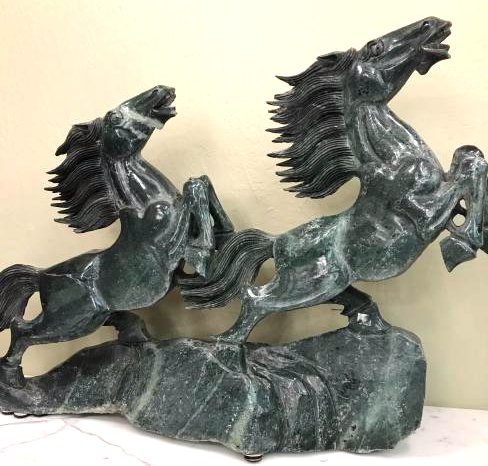 Solid Green Jade Statue of Two Wild Horses Running: Beautifully-carved solid jade statue depicting two wild horses running up a mountain. Jade is dark green with veins of white. Has excellent details. From a private estate. Measures approx. 24"H x 34"W