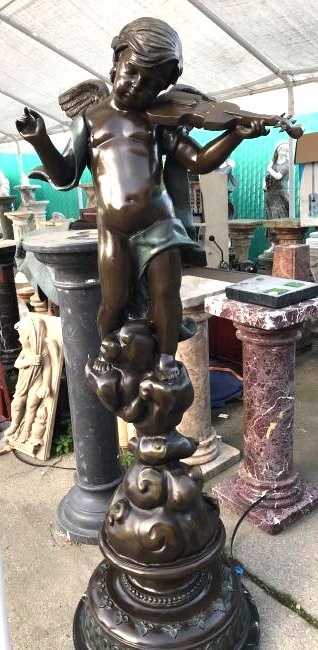 Large Bronze Cherub Playing Violin Statue by A. Moreau: Large bronze statue signed "A.Moreau," of a cherub playing a violin. Dual-patinated bronze mounted on a solid black marble base. Has good details. Measures approx. 70"H x 29"W x 24"D.