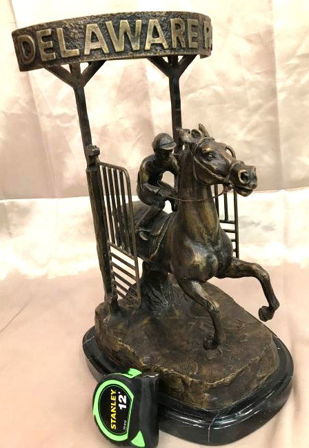 Bronze Statue of "Delaware Park" Racehorse: Bronze statue depicting the start of a "Delaware Park" horse rack with jockey. Gate on each side moves. Mounted on a solid black marble base. Great details From a private collection Measures approx. 1
