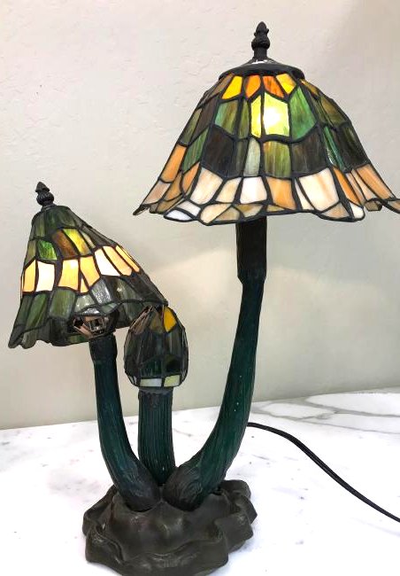 Tiffany-Style Stained Glass w/ Bronze Mushroom Lamp: Unique Tiffany-style stained glass and dual-patinated bronze lamp with group of three mushrooms. Measures approx. 20"H x 16"W x 8"D.