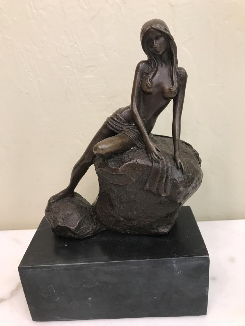 Nude Bronze Statue of Woman on Rock: Nude bronze statue of a woman sitting on a rock with good details. Mounted on a black marble base. In good condition. From a private collection, a local estate. Measures approx. 10"H x 6.5"W x 3.25"D.