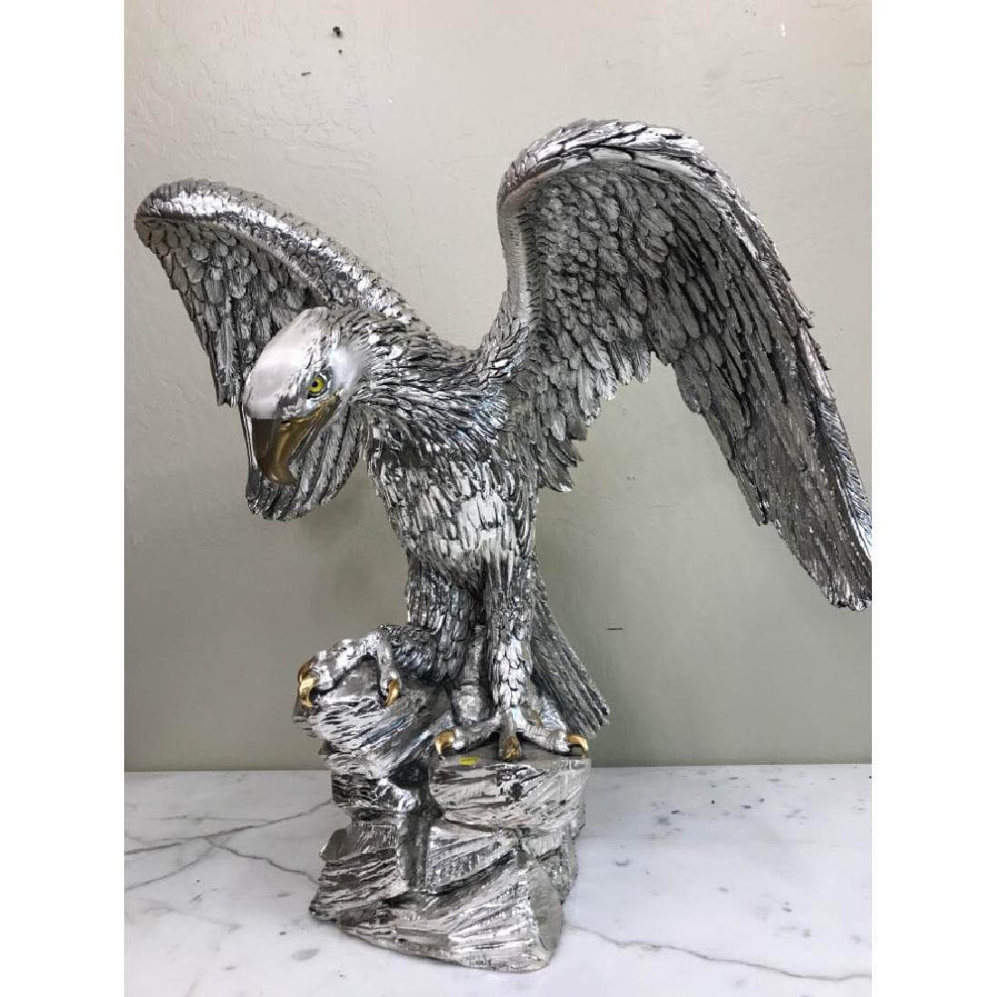 Bronze Eagle Statue w/ 24k Leaf: Bronze eagle statue with silver and 24k gold leaf. In good condition. Measures approx. 24"H x 26"W x 14"D.