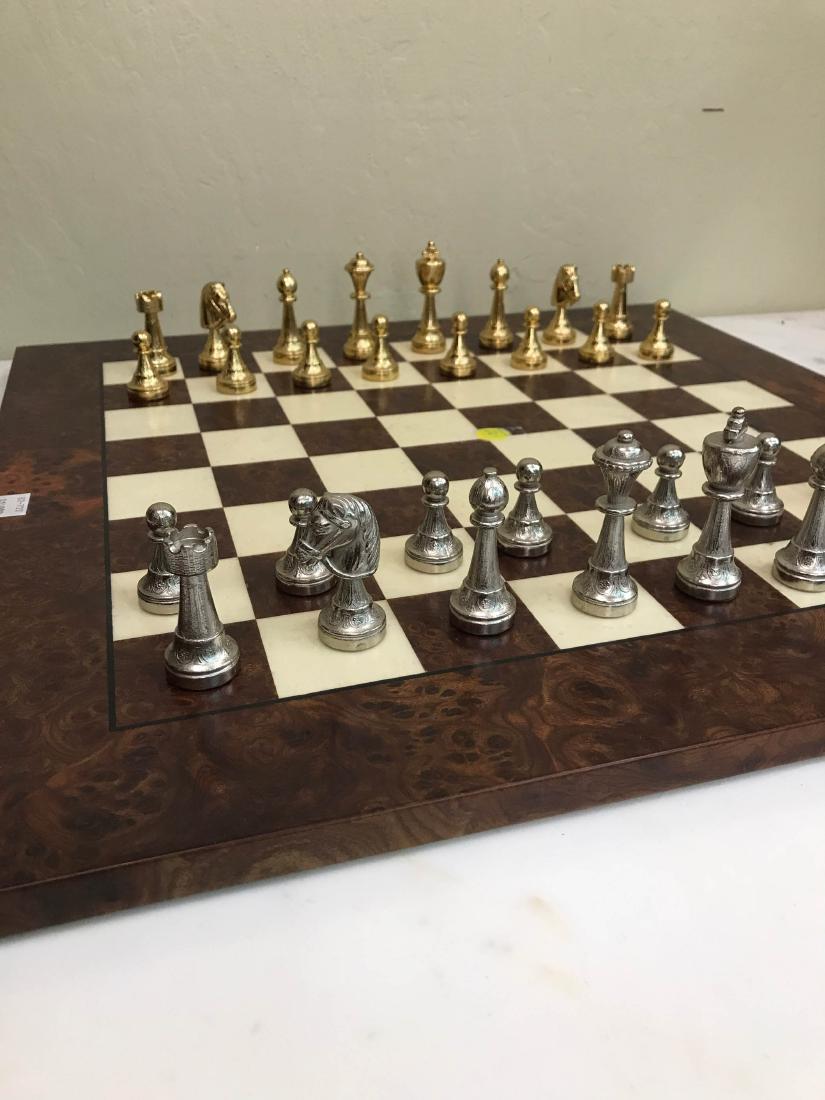 Italian 24k and Silver Bronze Chess Set: Chess set made in Italy with 24k gold plated and silver plated bronze game pieces with solid wood game board. Set is made with exceptional quality and detail. In good condition. Board measures approx.
