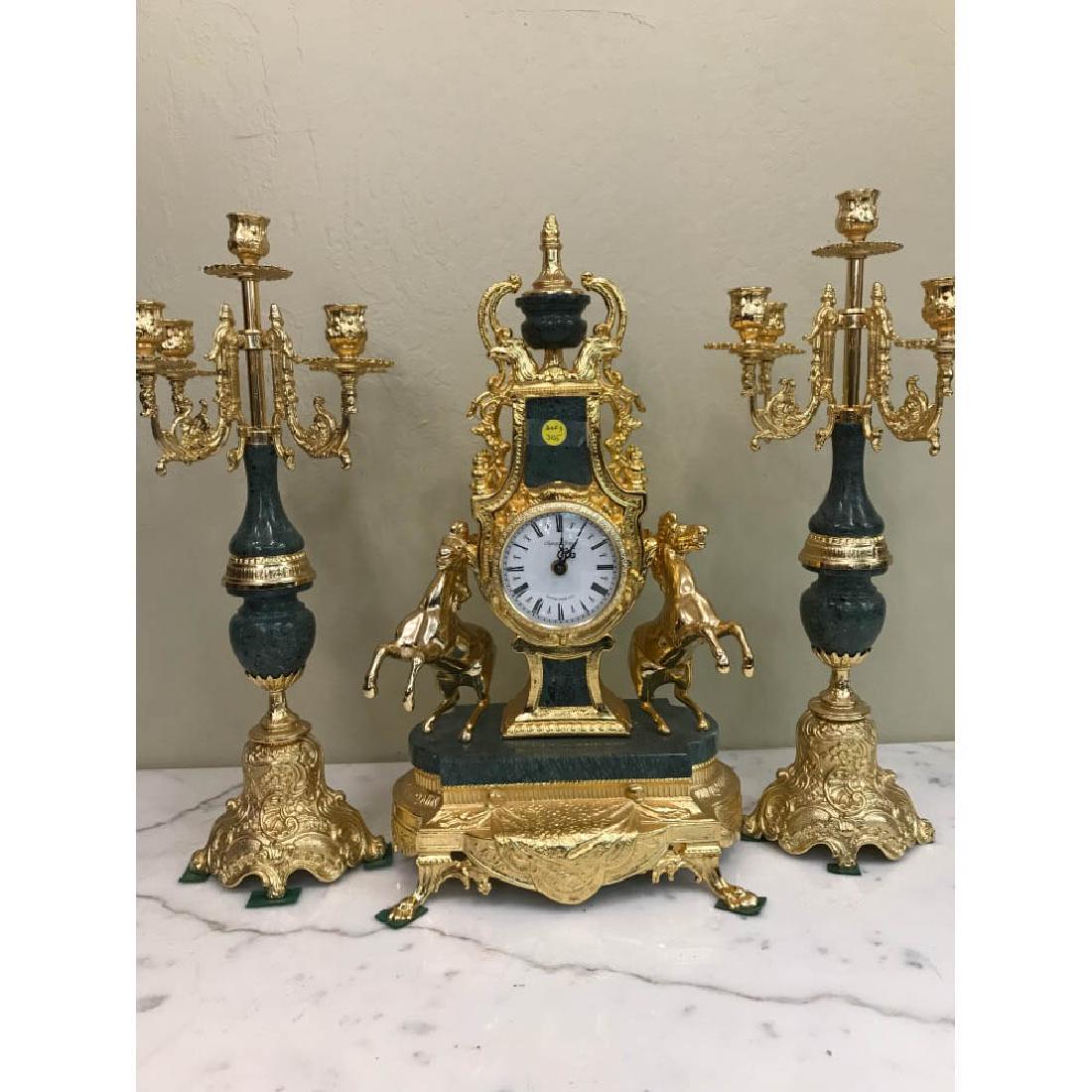 3-Piece Bronze Clock Set w/ 24k Leaf: Three piece bronze clock set with 24k gold leaf throughout. Has marble base. Clock measures approx. 20"h x 12"W x 6.5"D.