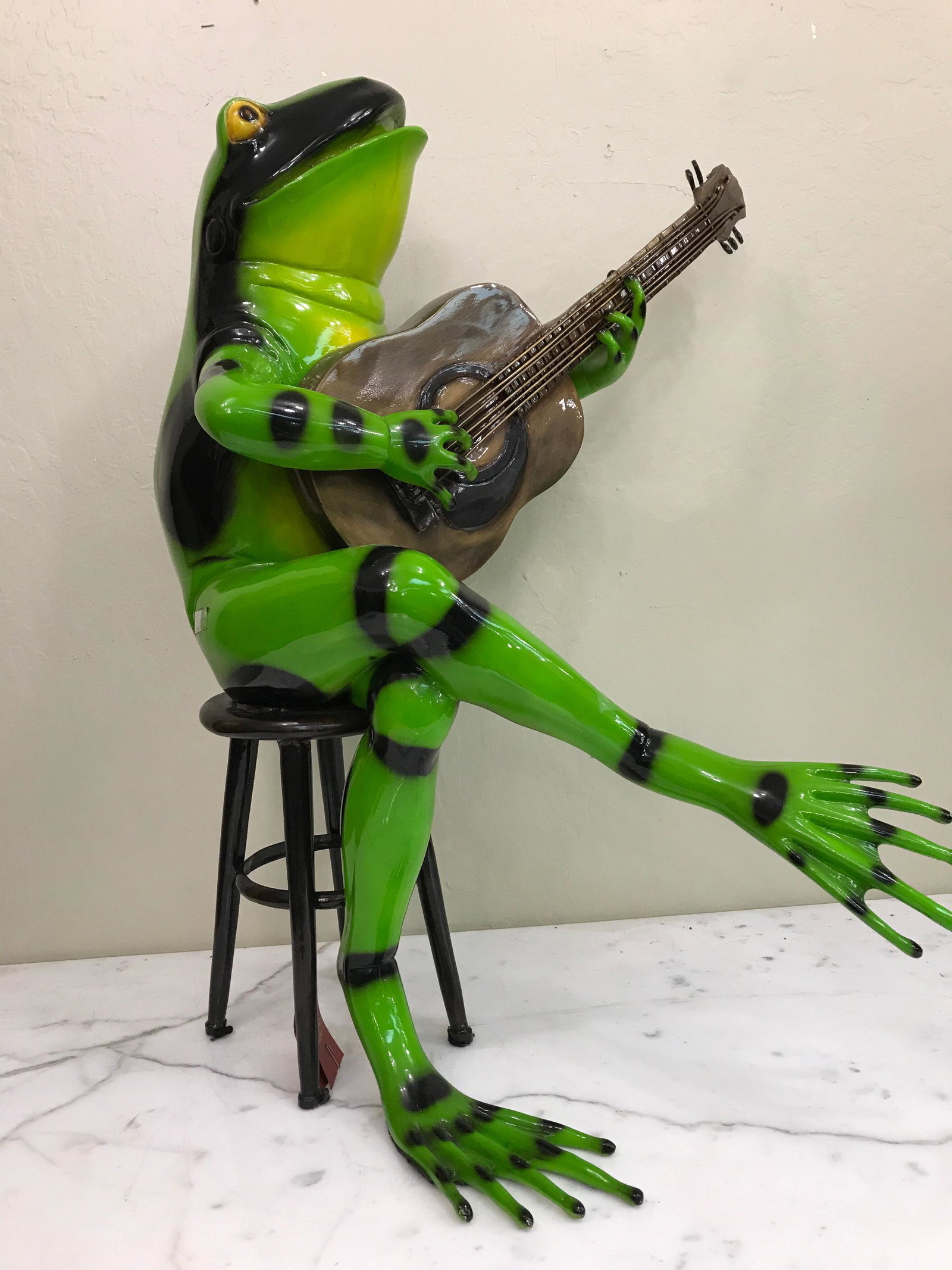 Bronze Statue of Frog on Stool Playing Guitar: Unique patinated bronze statue of a frog sitting on a stool with a microphone singing. In good condition, from a private collection. Measures approx. 29.5"H x 22"W x 22"D.