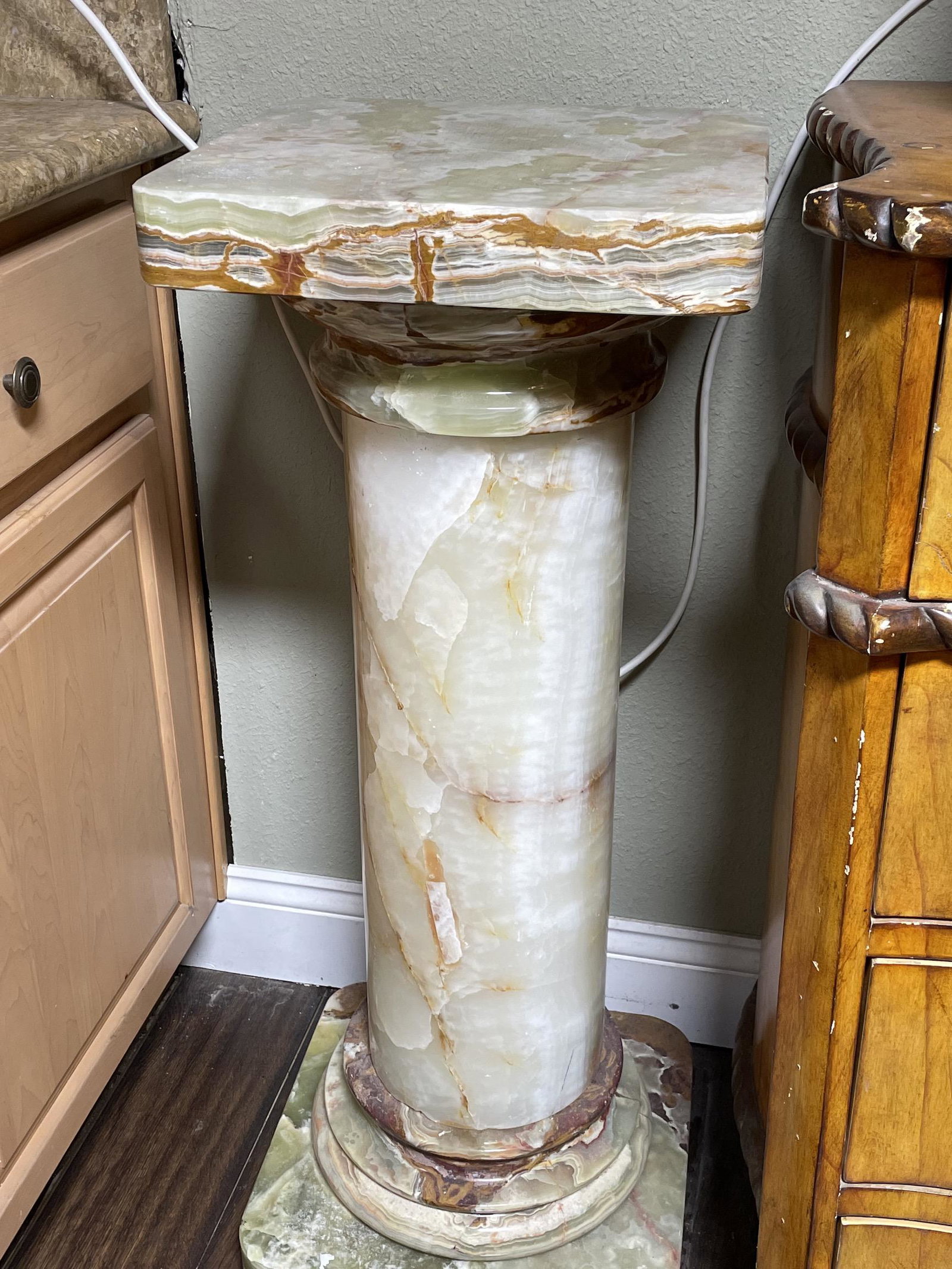 Green and Brown Onyx Pedestal: Onyx pedestal with green and brown colors. In good condition. Measures approx. 36"H x 14"W x 14"D on top.