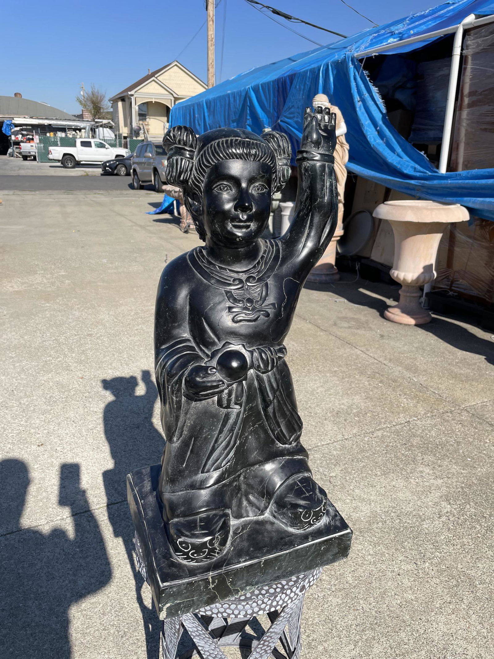 Black Carved Jade Statue of Religious Figure: Hand-carved solid black jade statue depicting a religious figure carved with good detail. In good condition. From a local estate. Measures approx. 28"H x 12.5"W x 11.5"D.