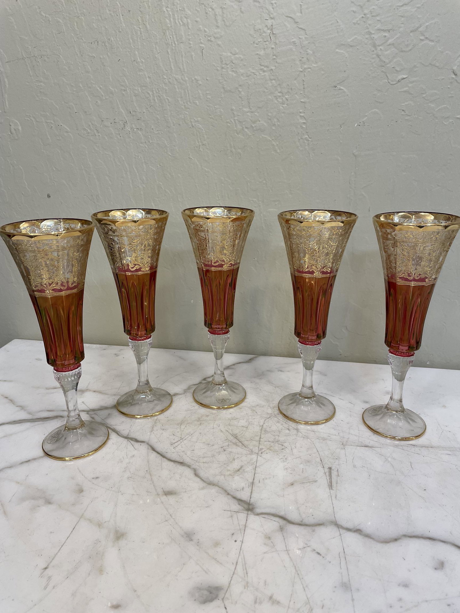 Set of 6 Crystal, 24k Goblets: Set of six crystal goblets red and clear in color with 24k gold leaf accents. Made in Italy. In excellent, never used condition. Each measures approx. 8.5"H x 3"diameter.