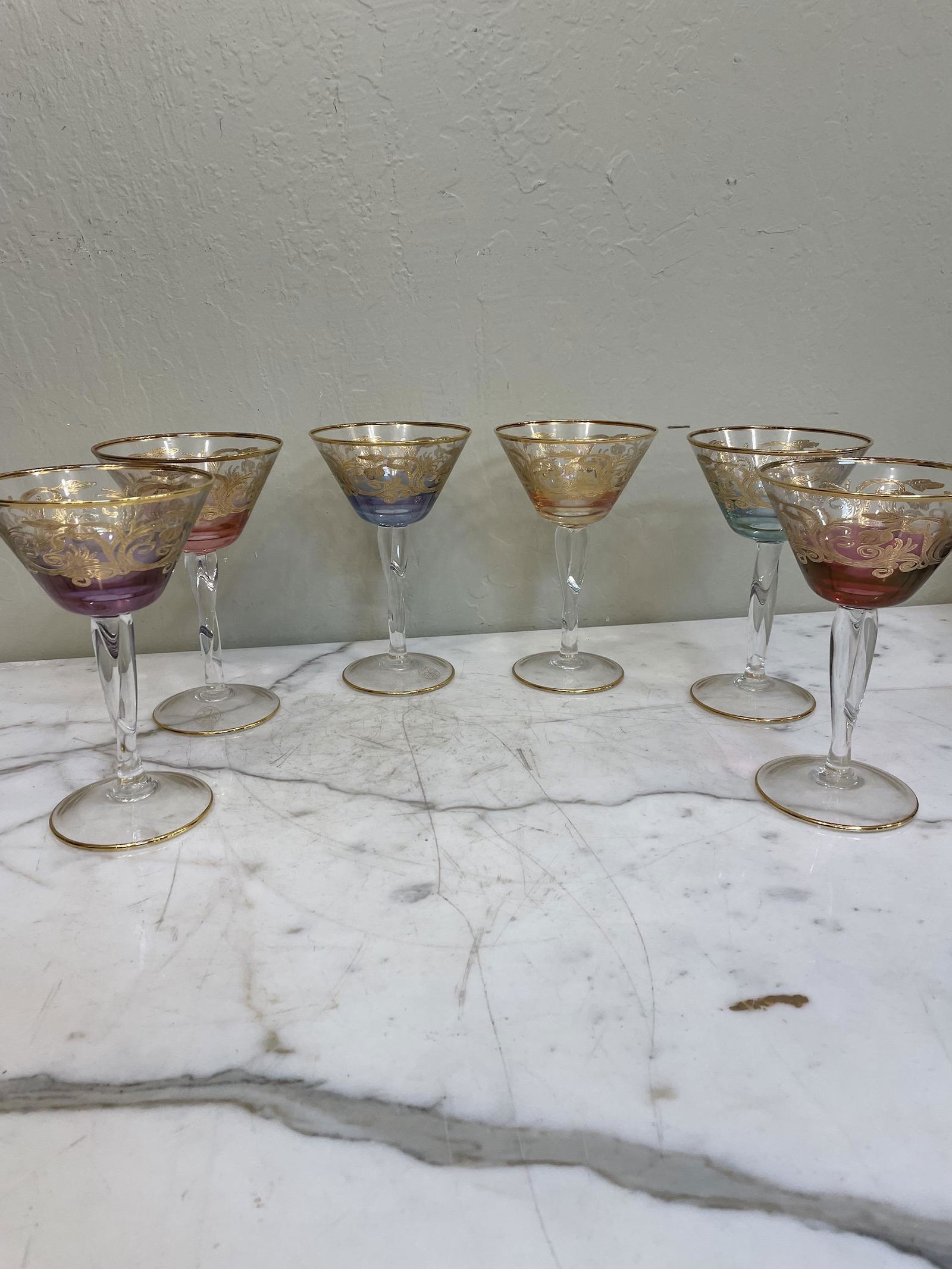 Set of 6 Multi-Colored Crystal Goblets: Set of six crystal goblets each a different color with 24k gold leaf accents. Made in Italy. In excellent, never used condition. Each measures approx. 7.25"H x 4.75"W.