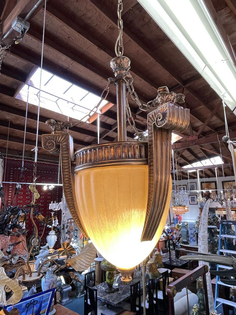 Art Deco Gilded Wood and Glass Chandelier: Art deco gilded wood and glass chandelier with good detail. In good, unused, working condition. Measures approx. 34"H x 19" diameter.