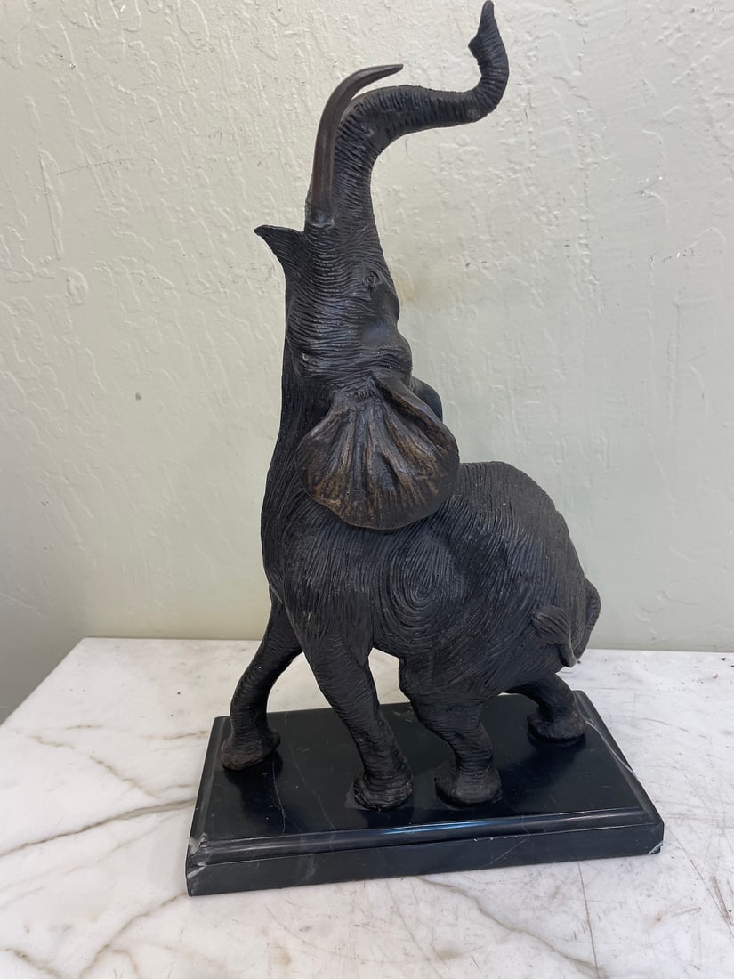 Bronze Elephant Statue with Marble Base: Bronze statue depicting an elephant with trunk up mounted on a solid black marble base. Good details. In good condition. Measures approx. 16.5"H x 10"W x 5"D.