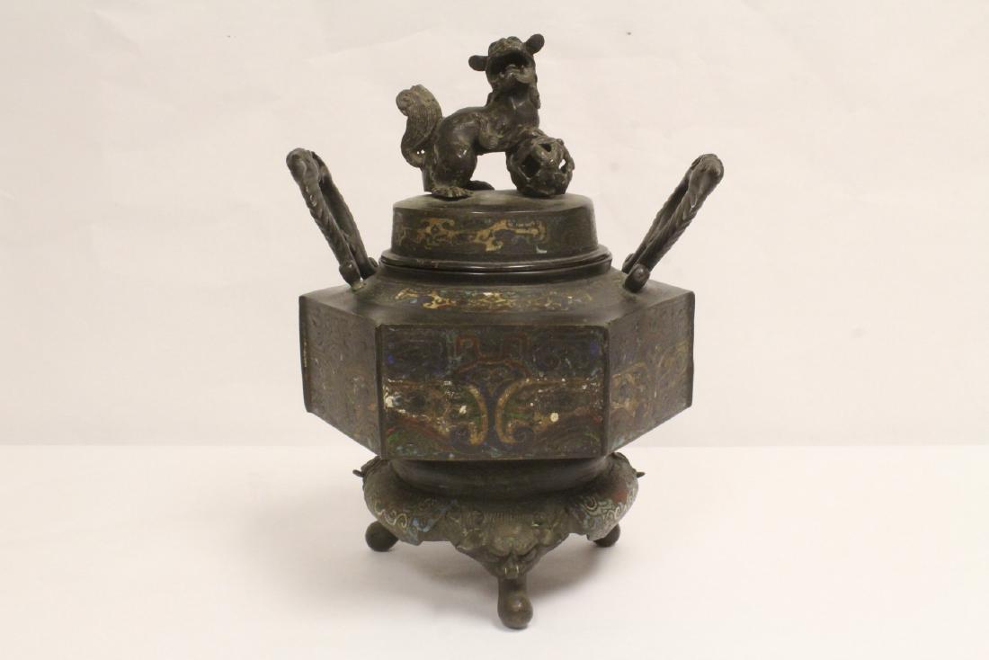 18ty/19th c. champleve bronze covered censer: An 18ty/19th century champleve bronze covered censer with legs in qilin head motif, finished with qilin motif finial, 12.75"Hx10"x8"