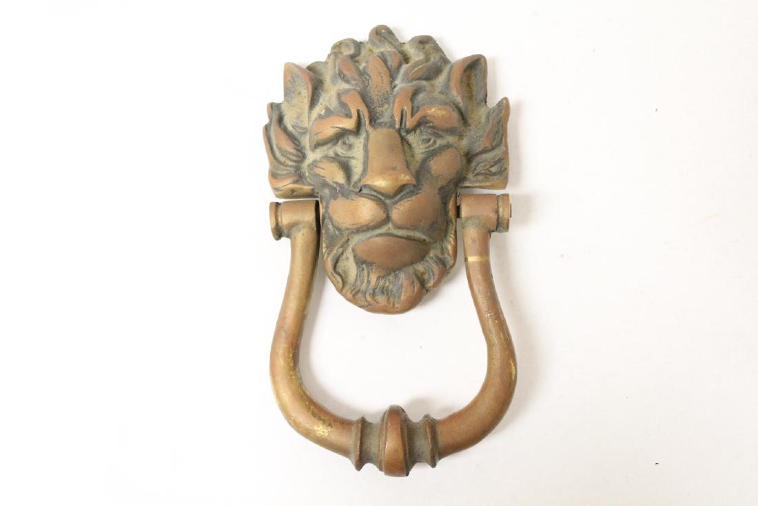 A bronze door knocker in lion motif: A bronze door knocker in lion motif, 9.35"H