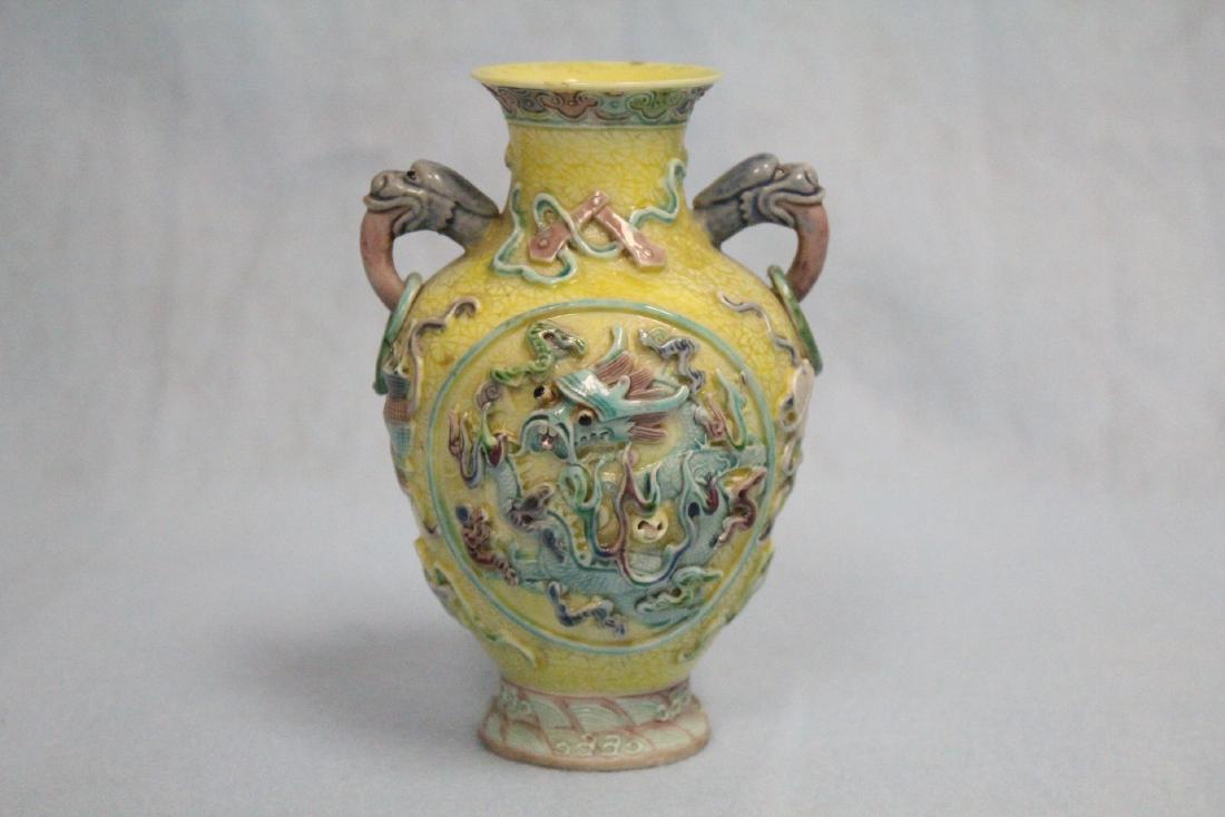 Chinese antique wucai porcelain vase, Qianlong mark: A beautiful Chinese antique carved wucai porcelain vase with dragon motif in high relief, Qianlong mark, 4.55"Hx3"dia