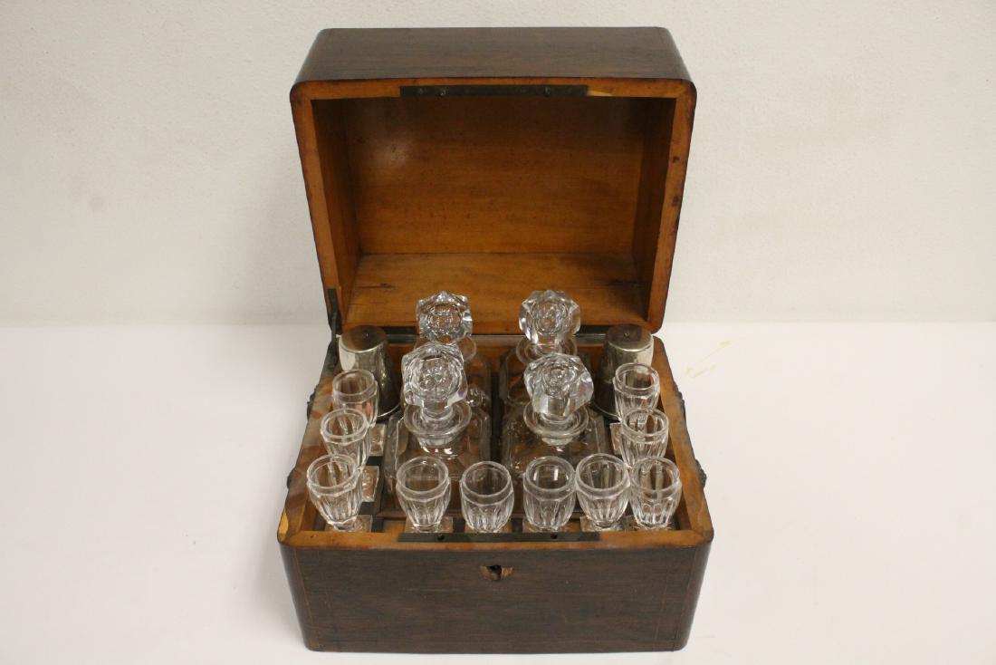 crystal tantalus wine serving set w/ original box: Fine crystal tantalus wine serving set; including 4 decanters (8.4"Hx3.05"x3.05" each), and 10 wine goblets (2.63"Hx4"dia each), attributed to Baccarat, with original presentation box (chips, 9.6"Hx12
