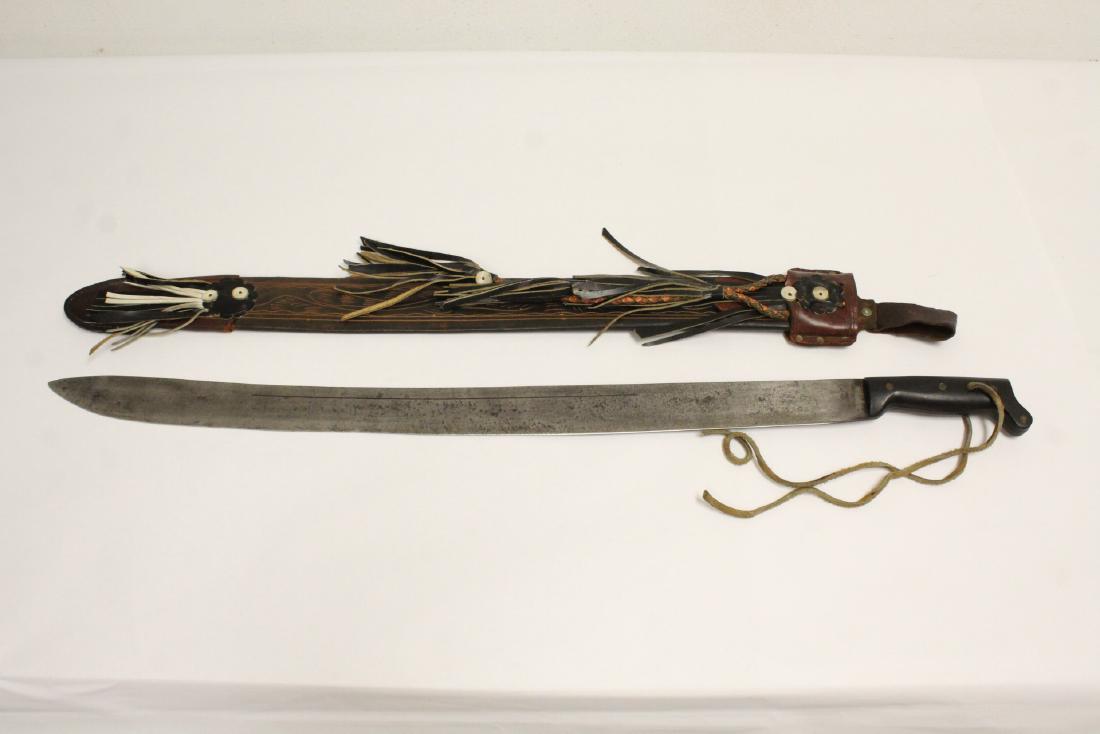 Machete with leather scabbard: Machete with leather scabbard, 33.55"L (blade: 27.6"L)