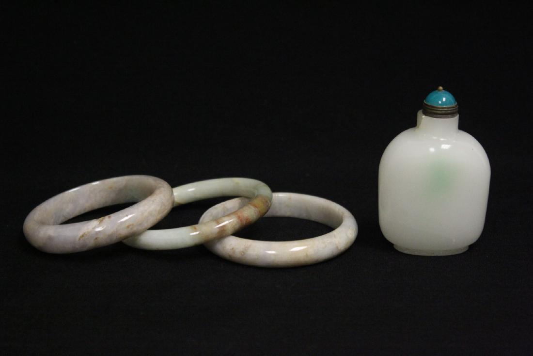 3 jade bangles, and a Peking glass snuff bottle: 3 jade bangles (cracks, 0.35"x2.95"dai, 0.5"x2.95"dia, 0.5"x2.85"dia), and a Peking glass snuff bottle (3"H)