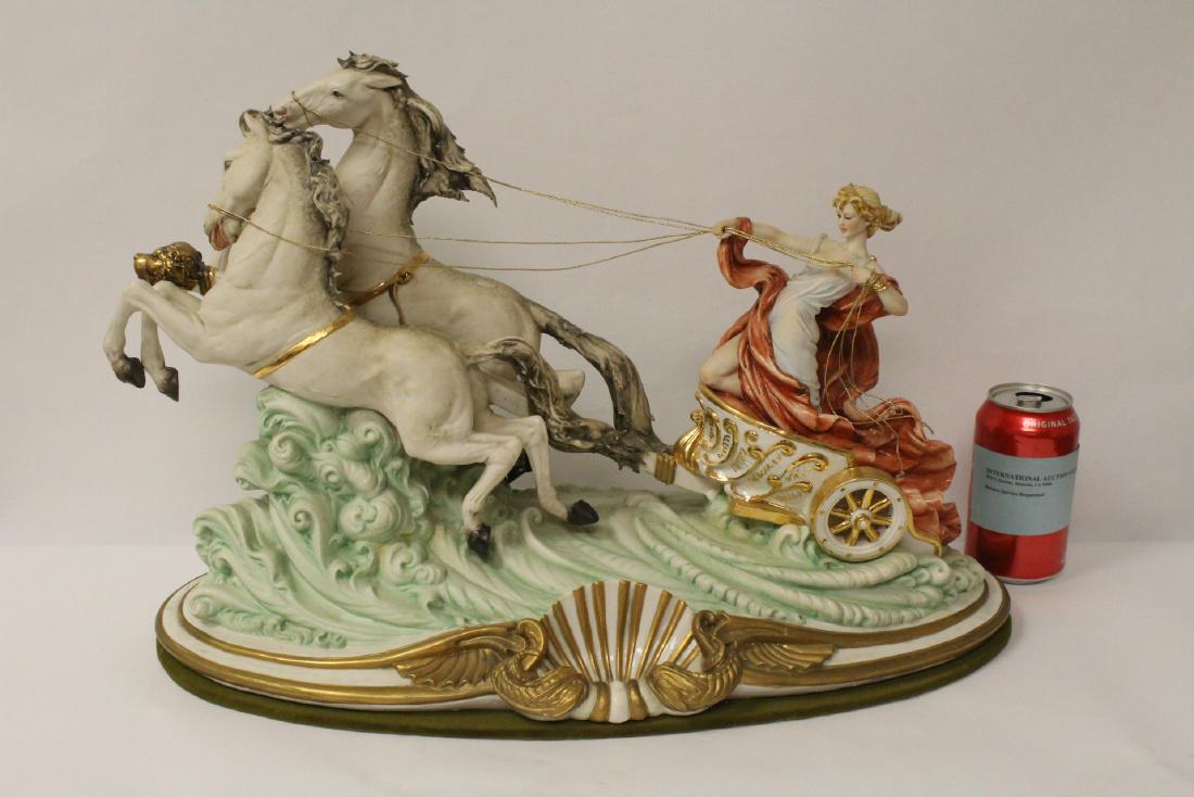 A beautiful capodimonte porcelain sculpture: A beautiful capodimonte porcelain sculpture "lady on chariot", 13.5"Hx20.5"x10.5"