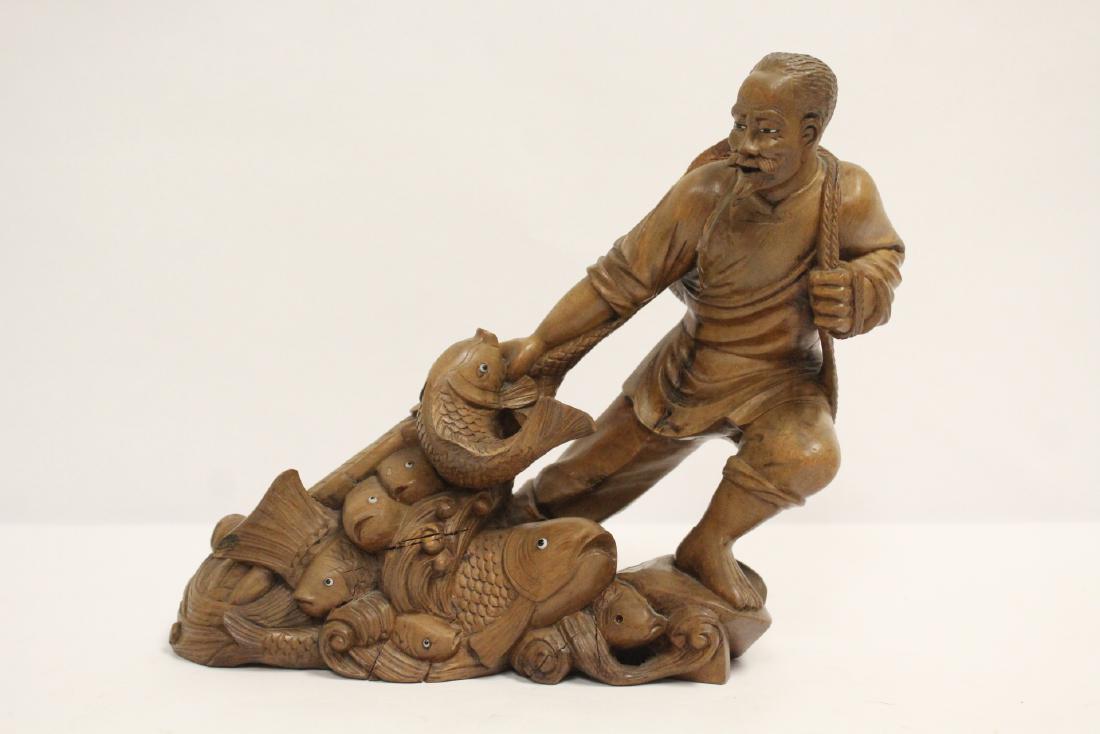 Wood carving depicting fisherman (1 of 10)