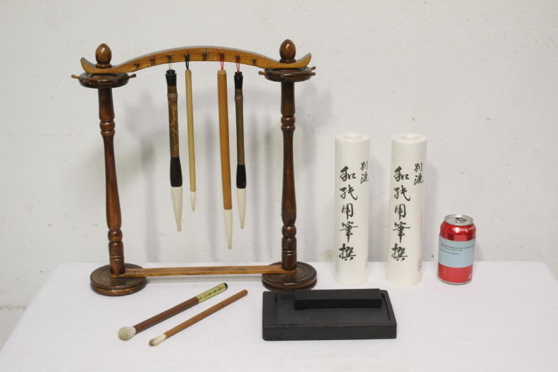 Chinese calligraphy set: Chinese calligraphy set; including 6 brushes (9.85"L - 13.45"L), a brush stand (17.75"H), ink stone (1.1"Hx8.75"x5.25"), ink stick (6"x1.6"x0.65") and 2 rolls of rice papers