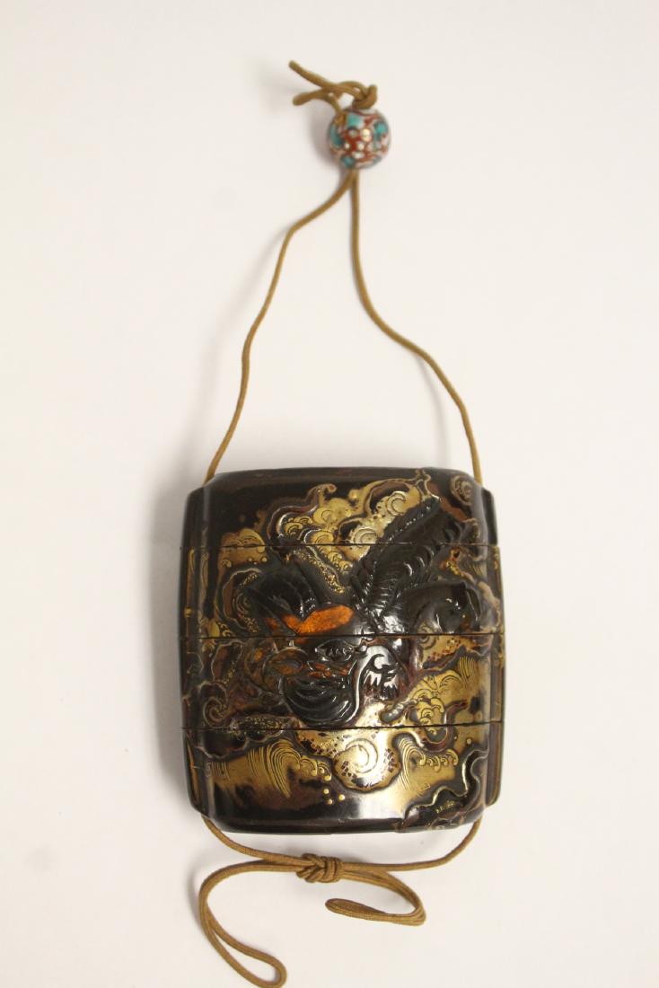 Japanese antique 4-section inro w/ a porcelain ojime: Japanese antique 4-section inro (2.7"x2.38"x1.1) decorated with dragon, attached to a porcelain ojime bead (0.5"dia)