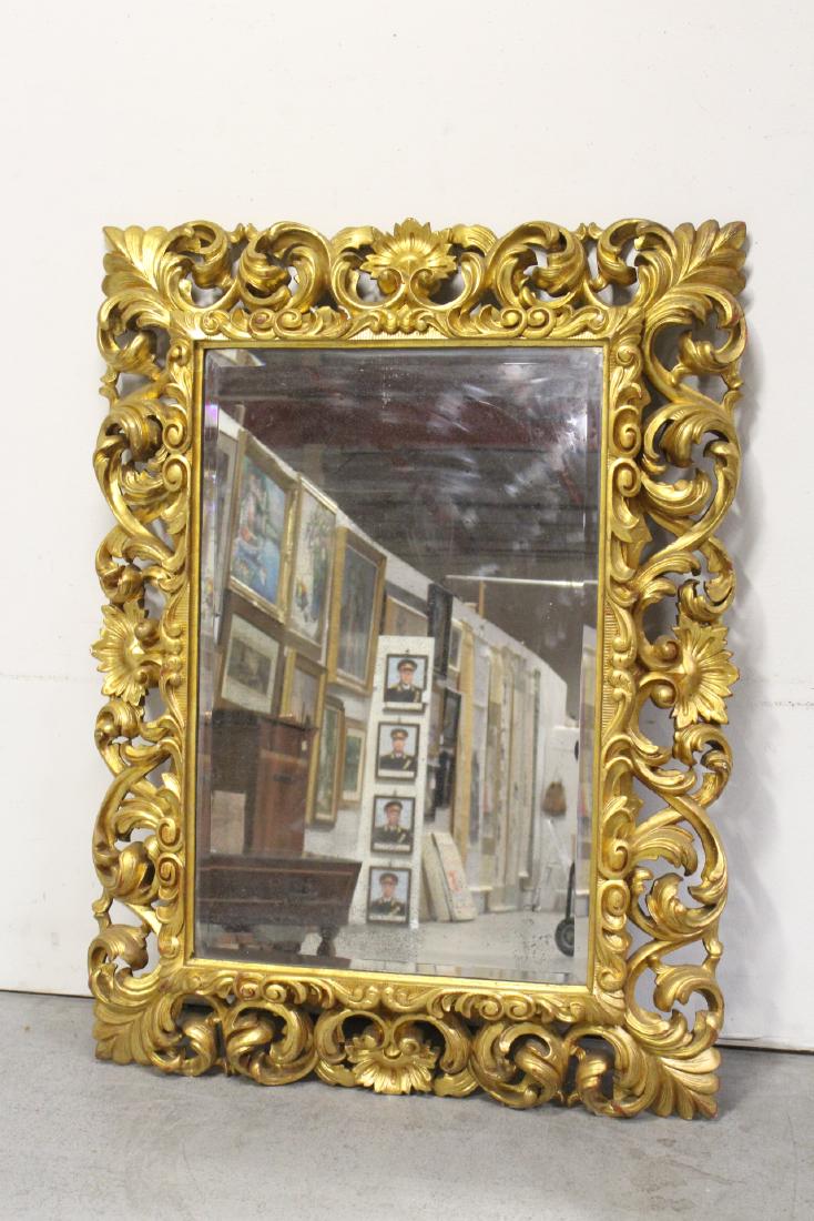 A massive giltwood rococo style wall mirror (1 of 10)