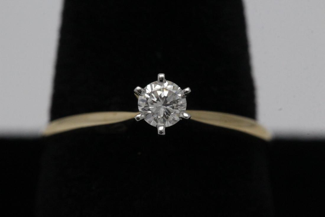 14K Y/G diamond ring: 14K Y/G diamond ring, center a gem quality diamond wt. approx. 0.25ct, size 6.5