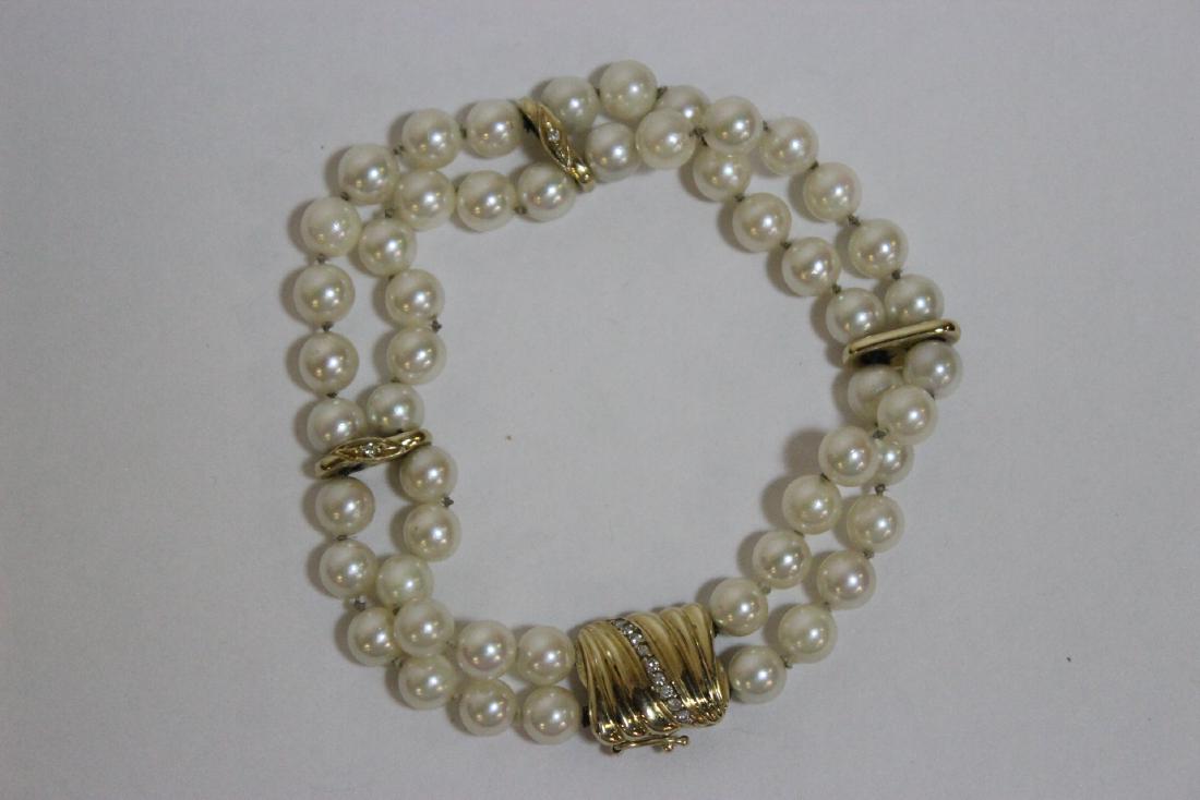 14K Y/G cultured pearl bracelet w/ 14K spacer & clasp: Fine 14K Y/G Mikimoto cultured pearl bracelet (8"L), each pearl measures approx. 6.5mm in diameter, with 14K Y/G spacer and clasp, with small diamonds enhancement, wt. 26gm