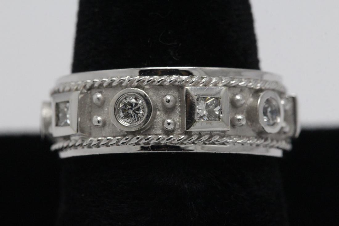 Beautiful 14K W/G diamond ring: Beautiful 14K W/G diamond ring set with 3 princess cut and 4 brilliant cut diamonds, tdw approx. 1.0ct, wt. 5.5gm, size 6.5