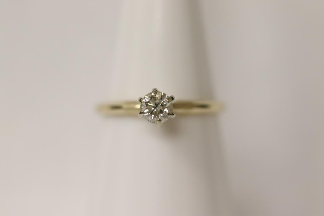 14K Y/G diamond ring: 14K Y/G diamond ring, center a gem quality brilliant cut diamond wt. approx. 0.25ct (VS/VVS, G/H), size 5