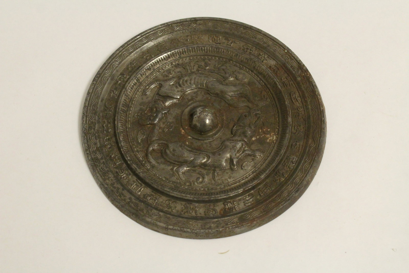 A Chinese round bronze mirror (1 of 8)