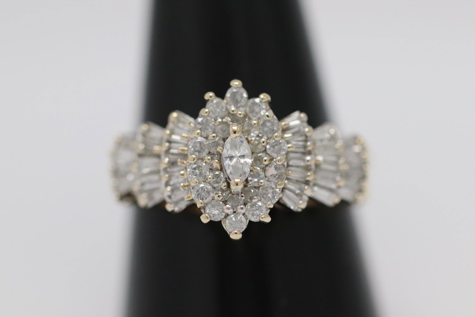 14K Y/G diamond rings: 14K Y/G diamond rings set with fine quality marquise brilliant cut and baguette diamonds, tdw approx. 1.10ct, wt. 5.1gm, size 9.2