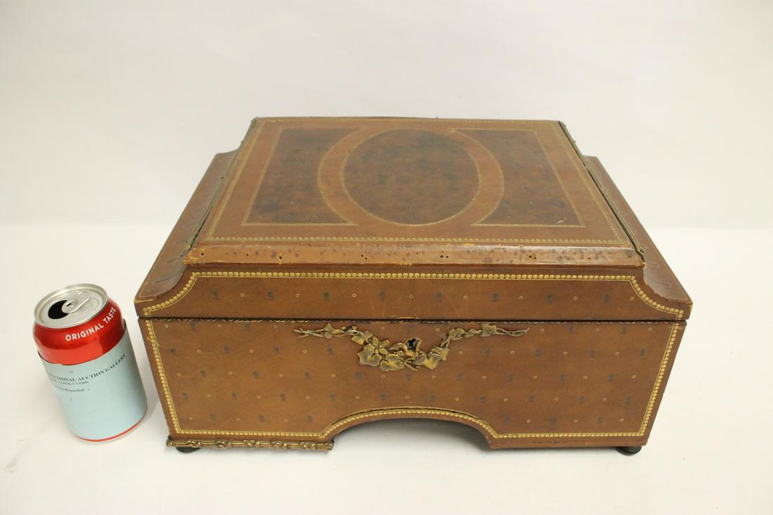 A beautiful leather tooled jewelry box: A beautiful leather tooled jewelry box, front one metal stripe missing, 7.63"Hx15"x10"