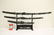 3 contemporary samurai swords on stand