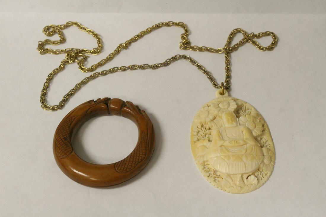 Antique wood ring, and a bone carving w/ necklace: Antique wood carved ring (0.4"x2.15"dia), and a bone carved pendant (2.4"x1.75"x0.35") with necklace