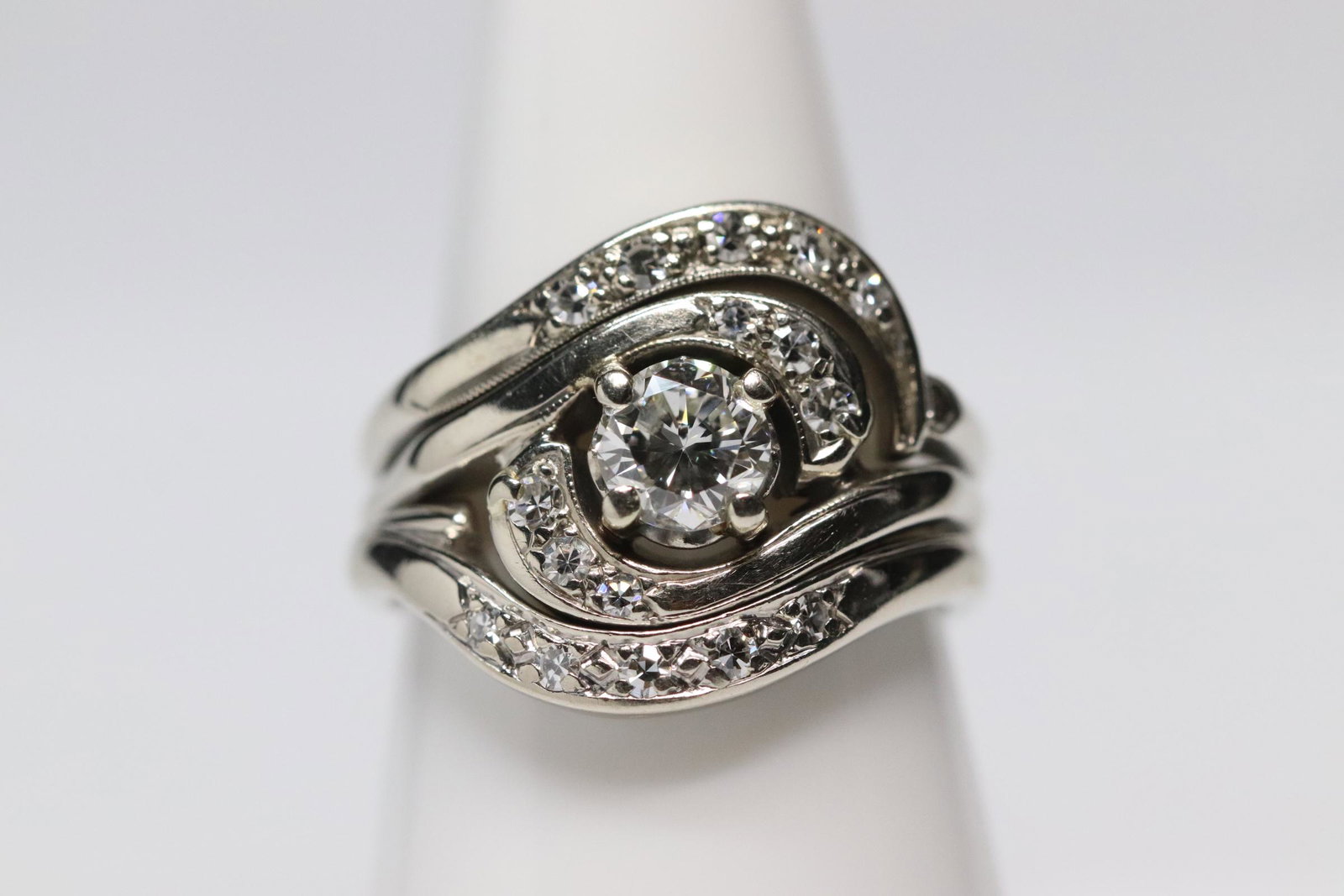 retro design 14K W/G diamond ring: A beautiful retro design 14K W/G diamond ring, center gem quality diamond wt. approx. 0.65ct (SI 1, G/H), accented by gem quality small diamonds, tdw approx. 1.0ct, wt. 7.3gm, size 6