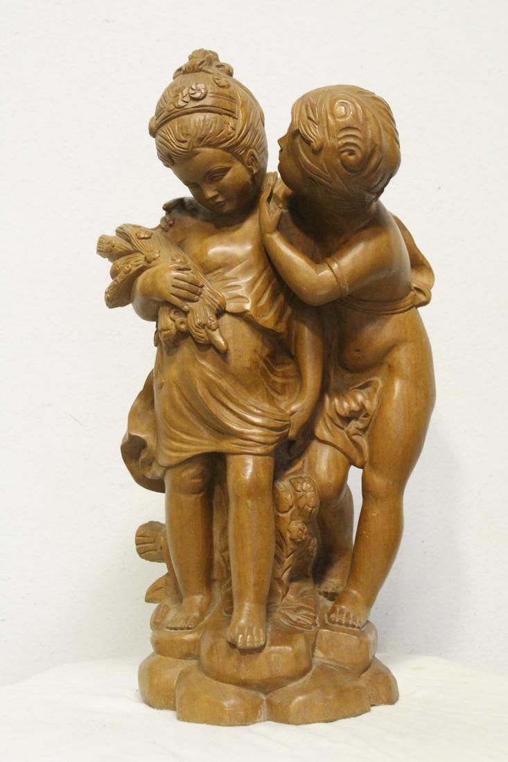 A large wood carving depicting boy and girl (1 of 10)