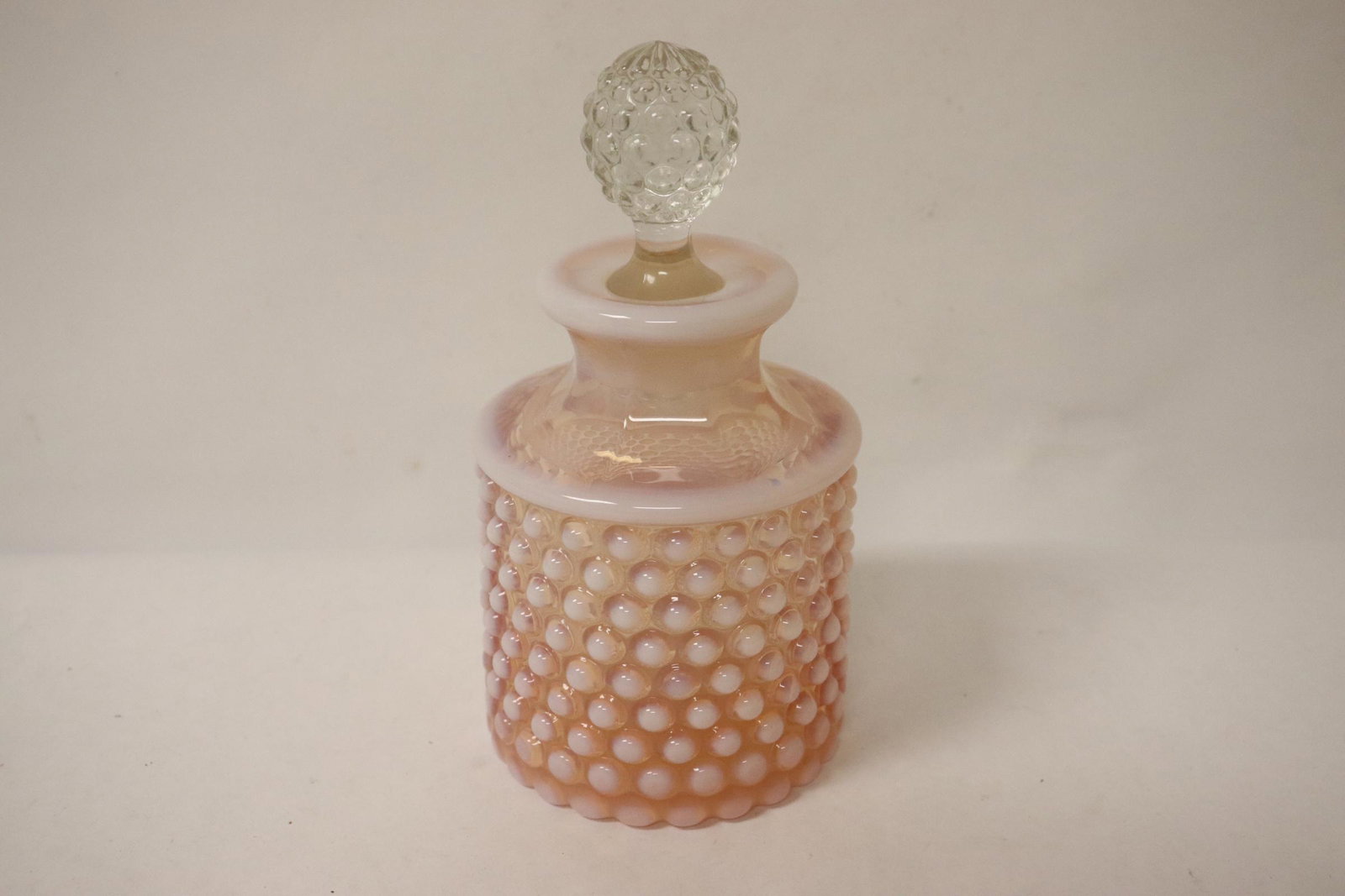 A Duncan Mill perfume bottle: A Duncan Mill perfume bottle, 6.2"Hx3.2"dia