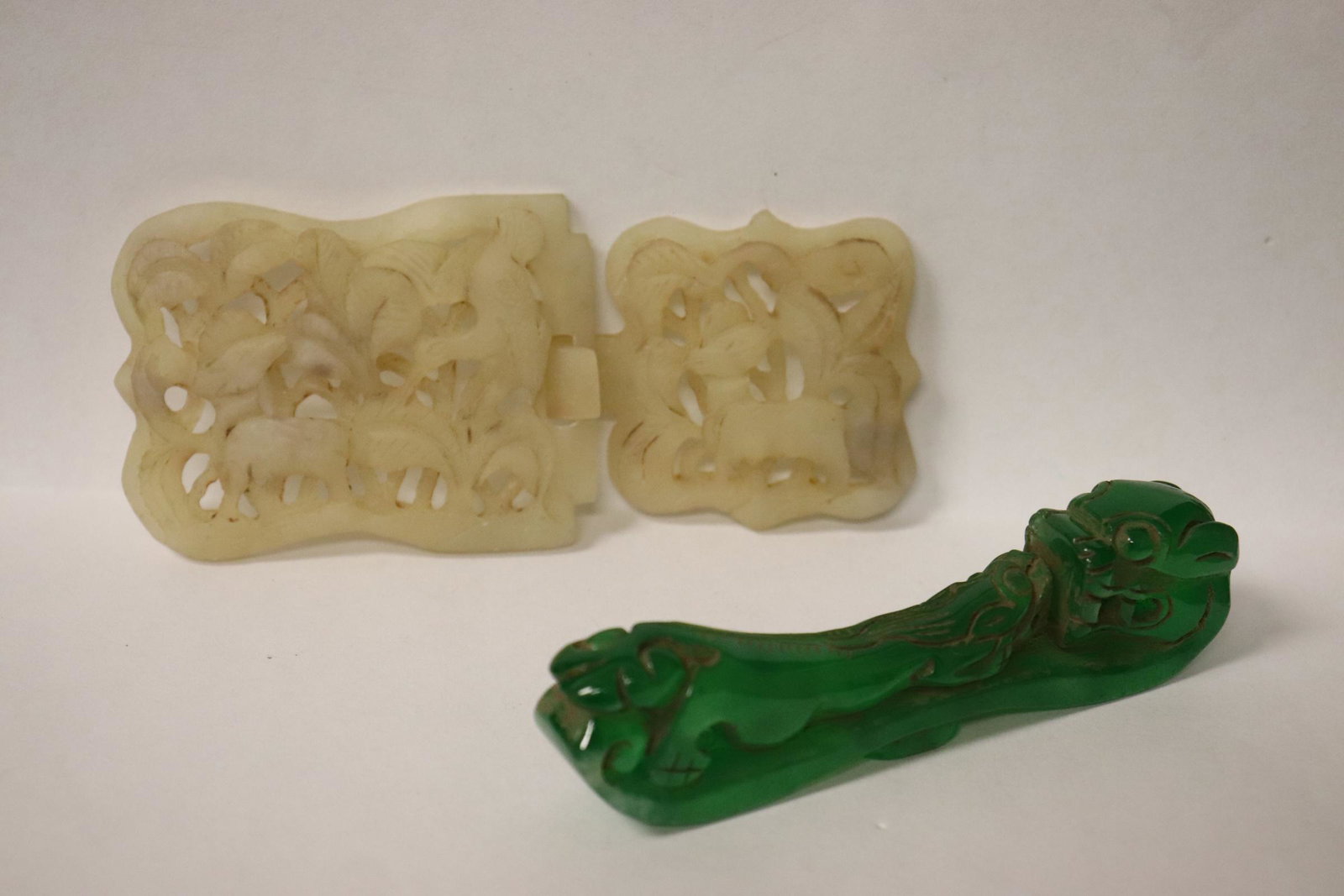 Jade carved belt buckle & a Peking glass belt buckle: Jade carved belt buckle (4.2"x1.85"x0.38") and a Peking glass belt buckle (3.65"L)