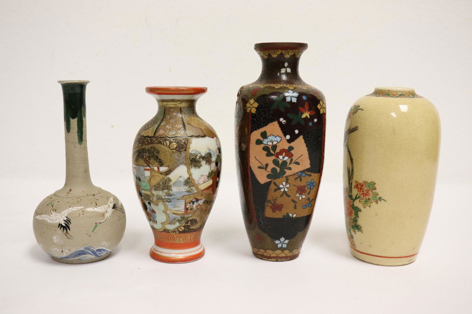 4 pieces: 4 pieces; 3 Japanese porcelain vases (one top repair, 4.8"Hx2.35"dia, 4.85"Hx2.5"dia, 4.8"Hx2.5"dia), and a Japanese antique cloisonne vase (damage, 6"Hx2.75"dia)