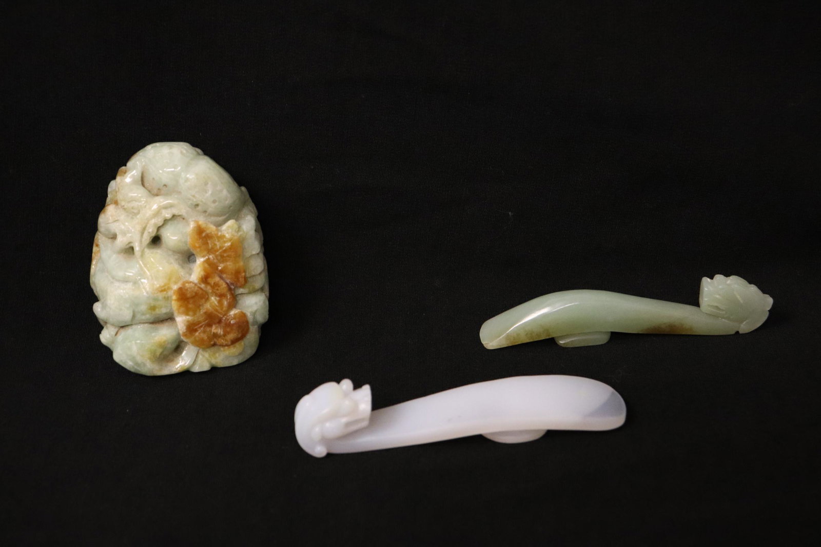 A jadeite ornament, & 2 belt buckles: A fine jadeite ornament (2.55"x2"x1.25"), a celadon jade belt buckle (3.3"L) and a Peking glass belt buckle (3.5"L)