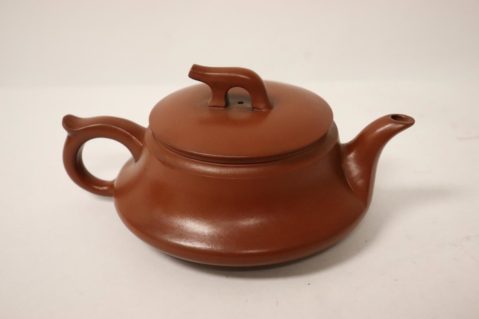 A Yixing teapot: A Yixing teapot, 3.25"Hx6.85"x5.2"