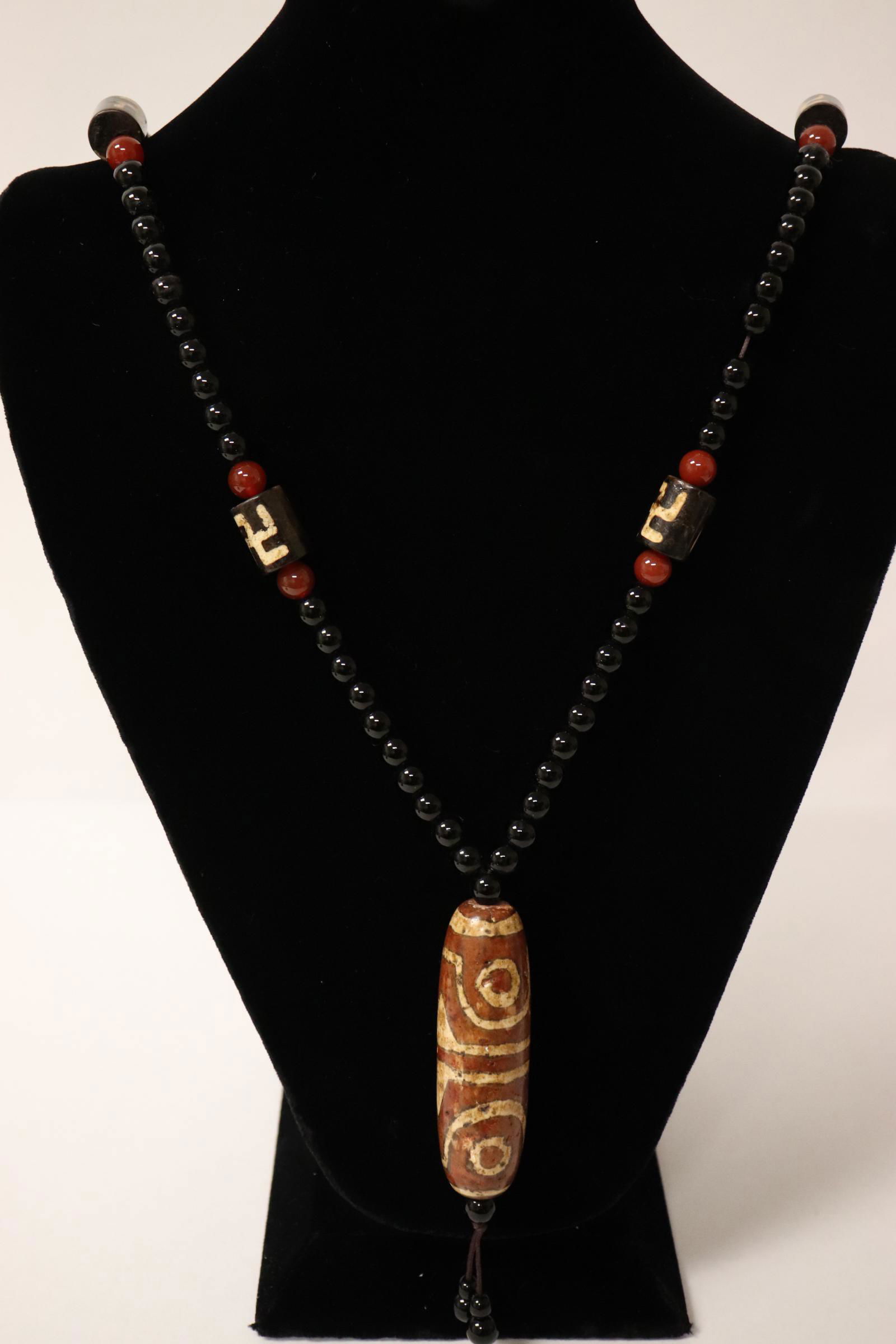 A Chinese large dzi bead attached to a necklace (1 of 11)