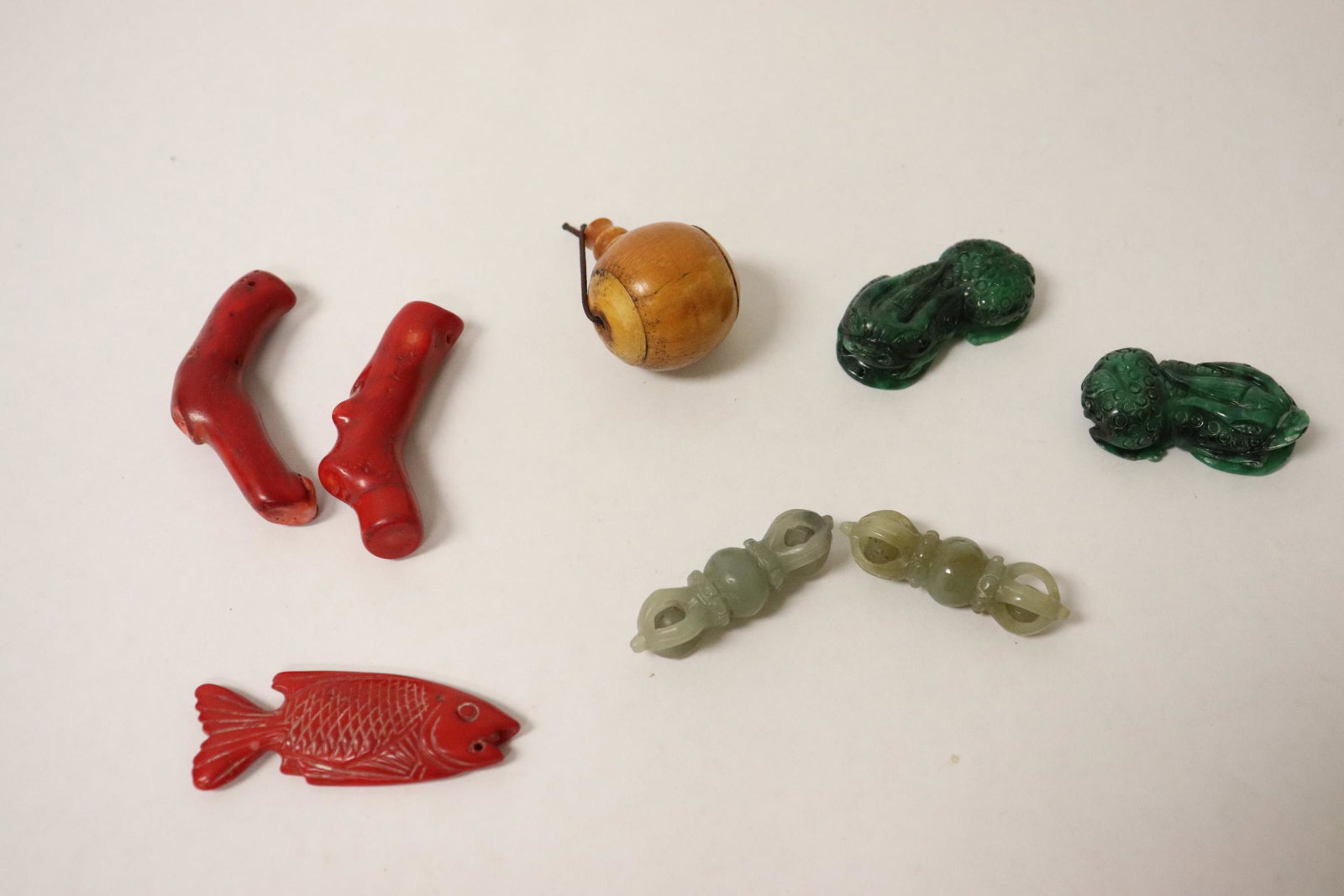 lot of misc.: 2 malachite carved fish (1.75"L each), 2 jade ornaments (1.8"L each), a bone carved ornament (1.2"dia), and 3 coral like ornaments (2.2"L - 2.4'L)