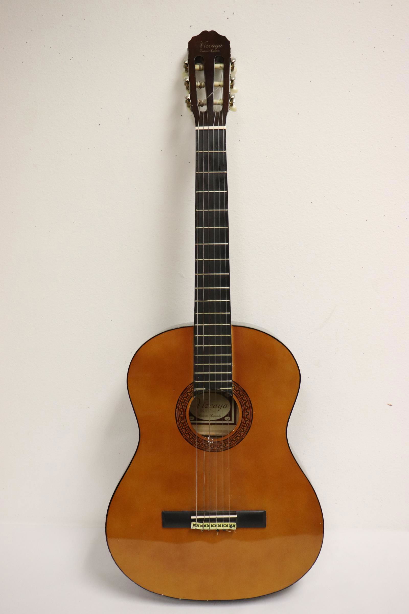 A vintage acoustic guitar, string loose (1 of 10)