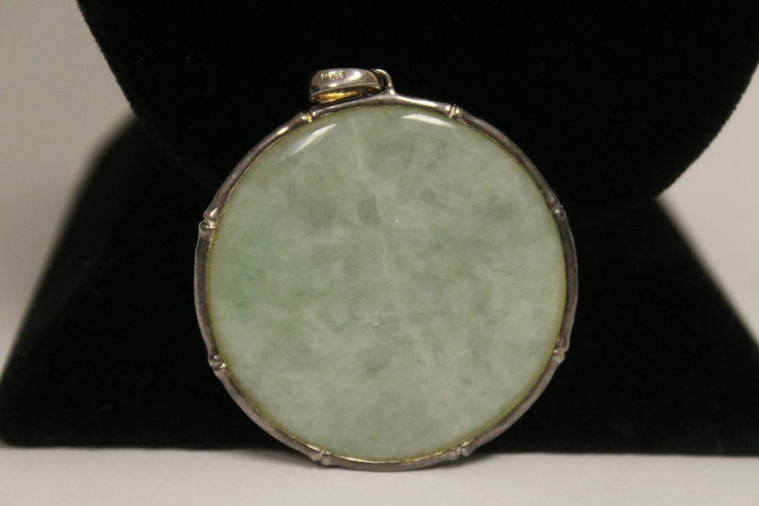 apple green jadeite disc w/ sterling silver bezel &: A large apple green jadeite disc with sterling silver bezel and hook, jadeite measures approx. 45mm in diameter