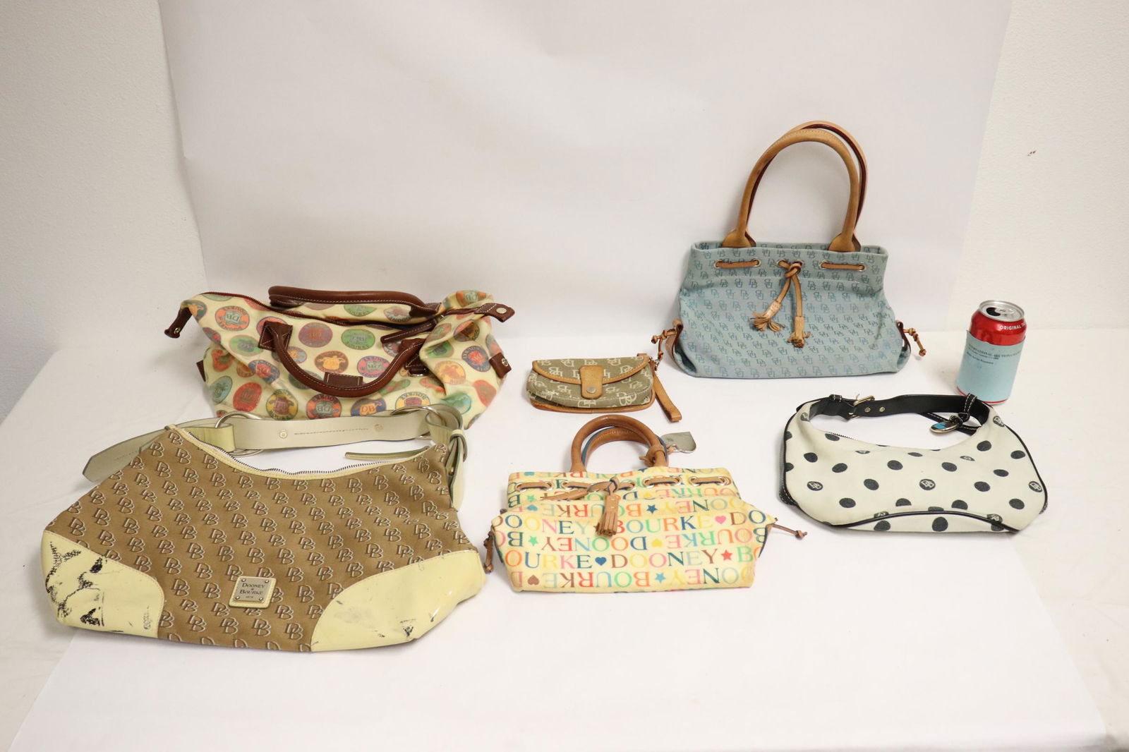 5 Dooney and Bourke handbags and a wallet: 5 Dooney and Bourke handbags and a wallet; one bag leather has stain