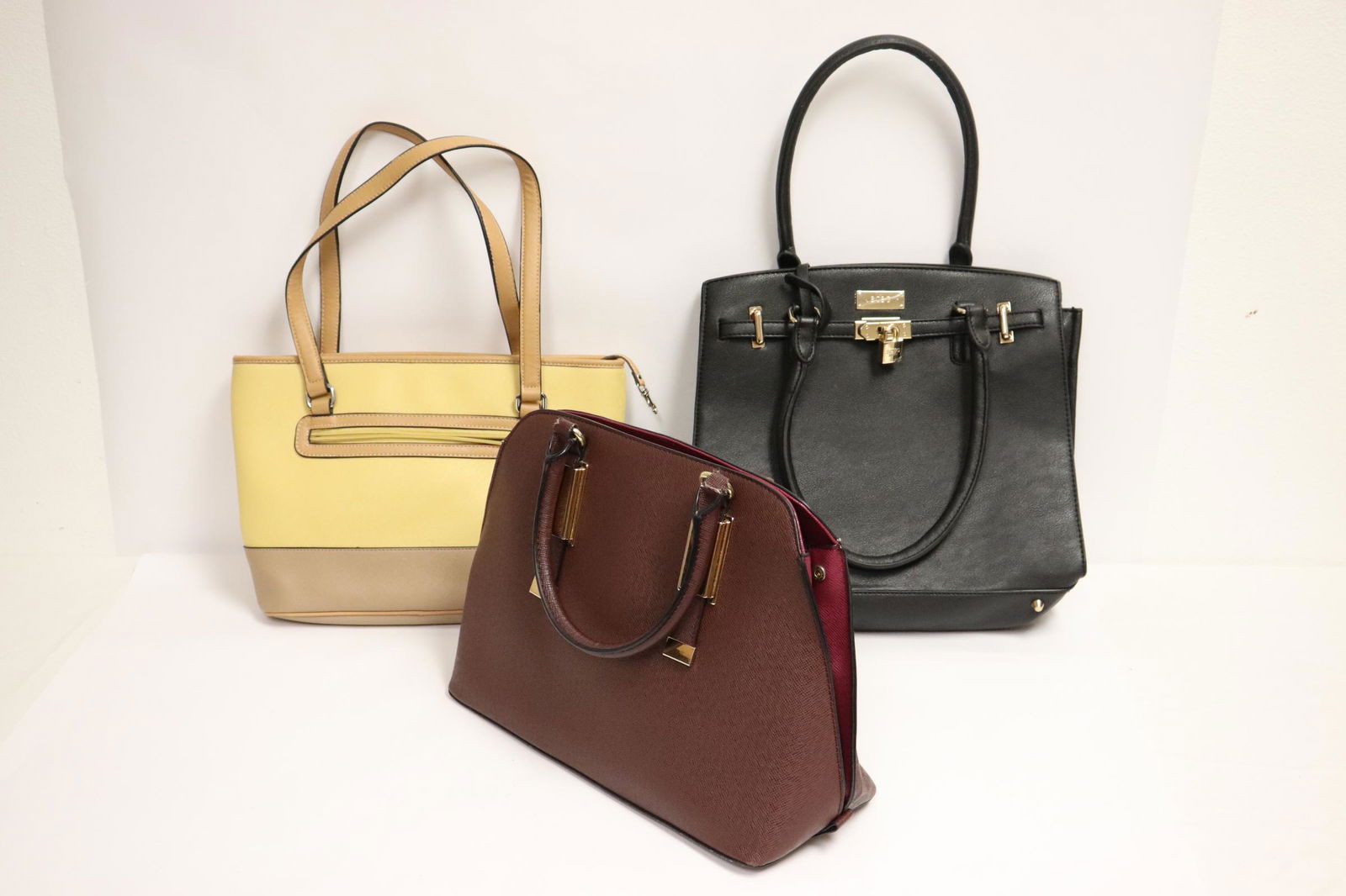 3 leather handbags: 3 leather handbags; Aldo, BCBG (pair), and Giani Bernini, all in as new condition